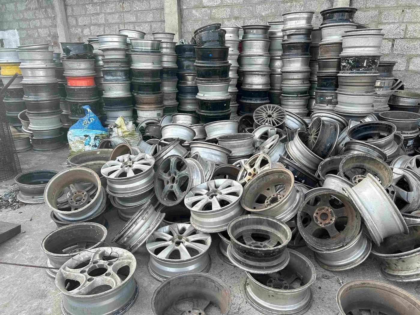 Stacked aluminium scrap car wheels ready for processing