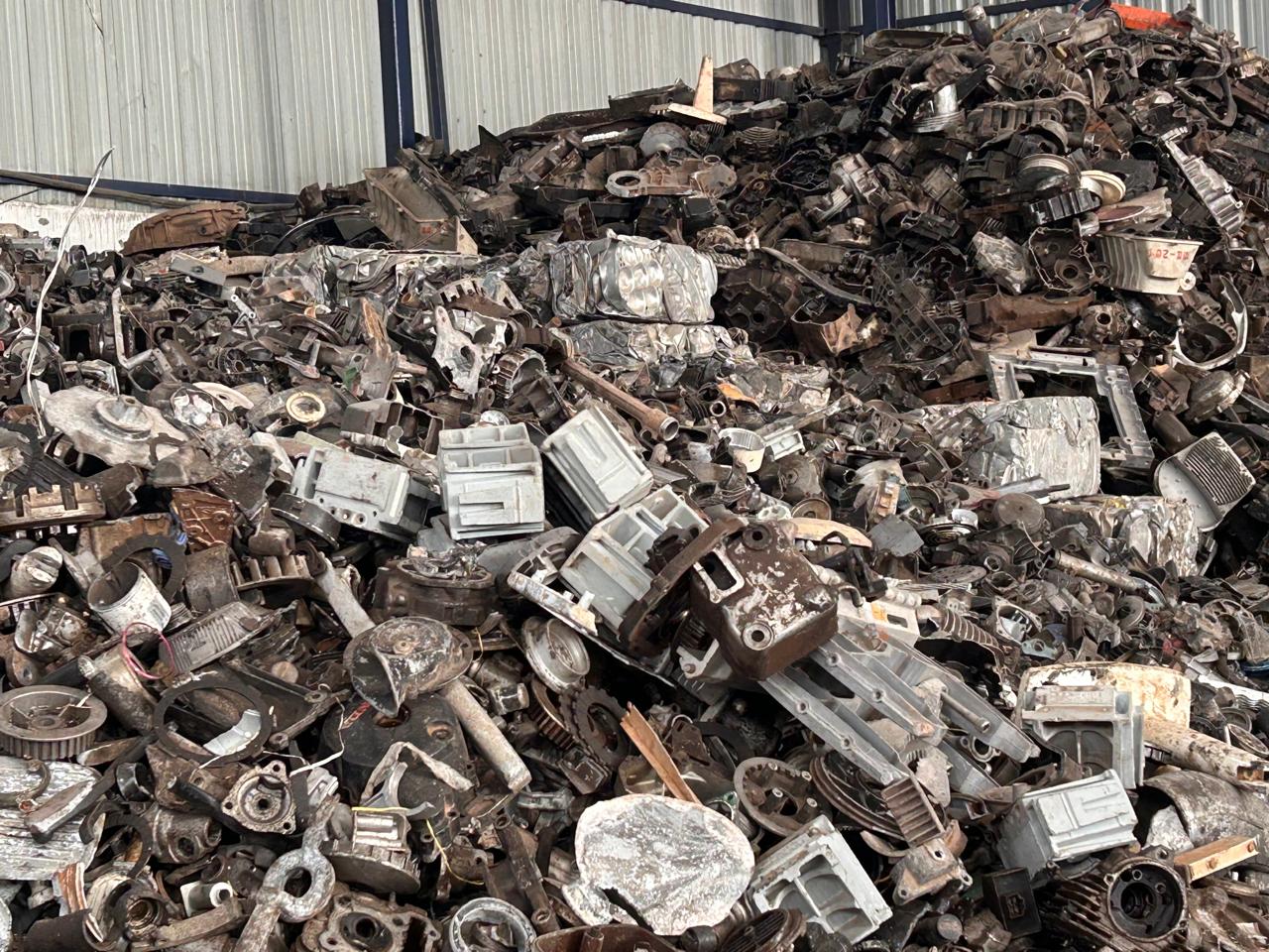 Silumin scrap — aluminium-silicon alloy engine part castings piled in the yard